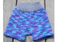 Hand knit from 100% wool in blues and purples trimmed with